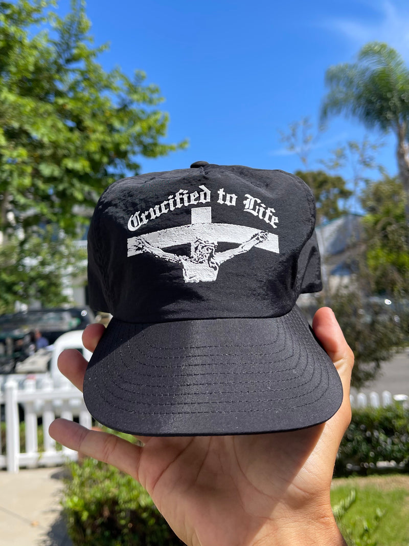 Crucified to Life hat by War Within, black cap with white crucifix screen print