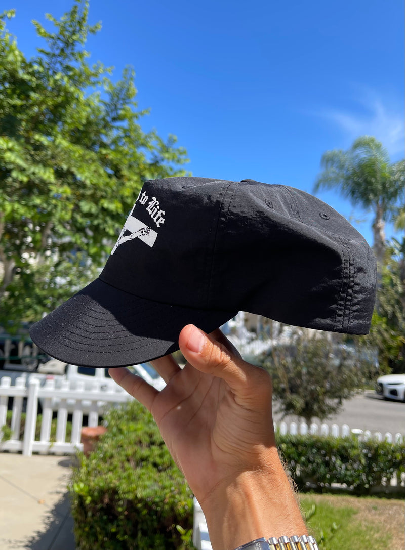 Crucified to Life hat by War Within, side profile of the black cap